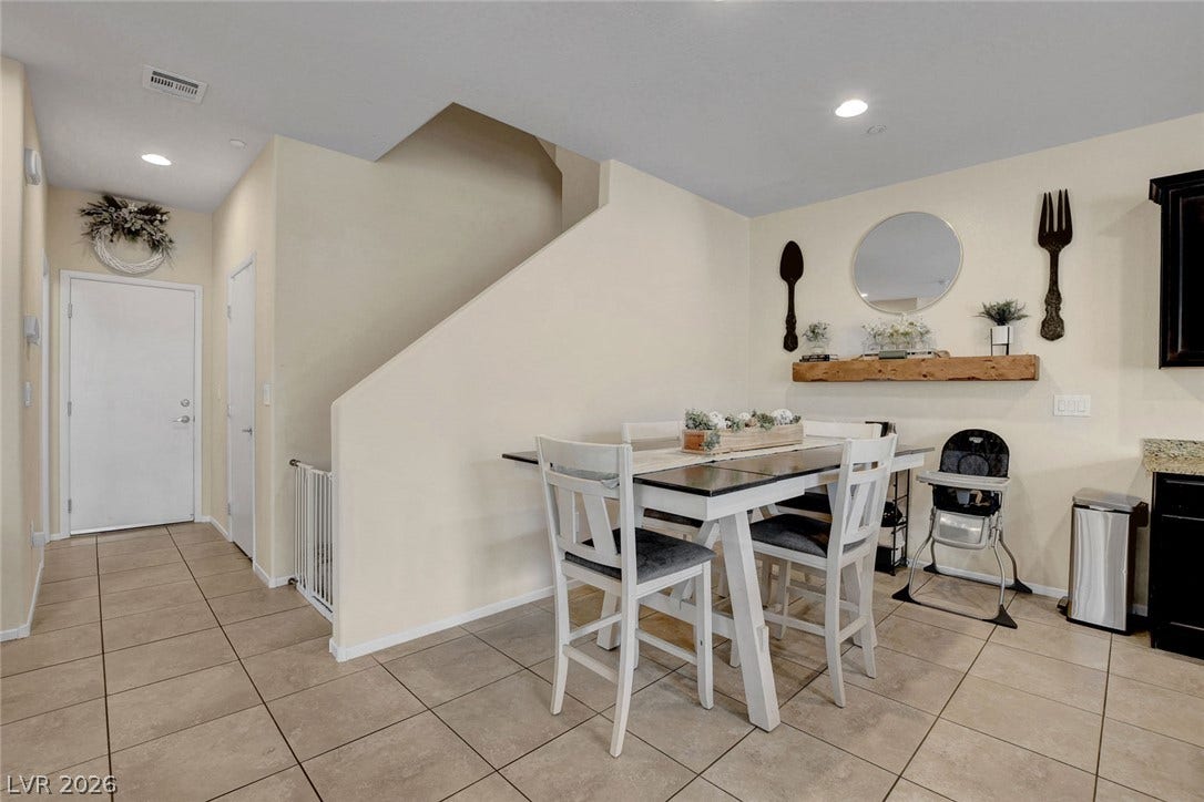 3924 Juanita May Avenue, North Las Vegas, NV 89032 Tiled flooring runs throughout this open dining area positioned beside the staircase.