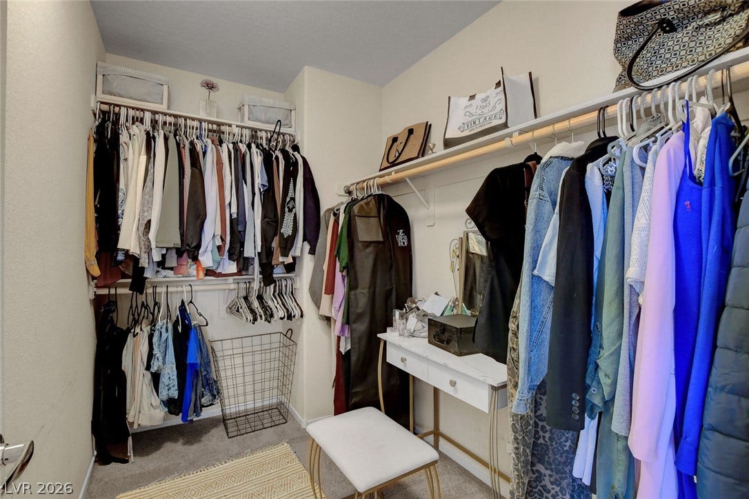 3924 Juanita May Avenue, North Las Vegas, NV 89032 Ample hanging rods and built-in shelving maximize storage space in this carpeted walk-in closet.