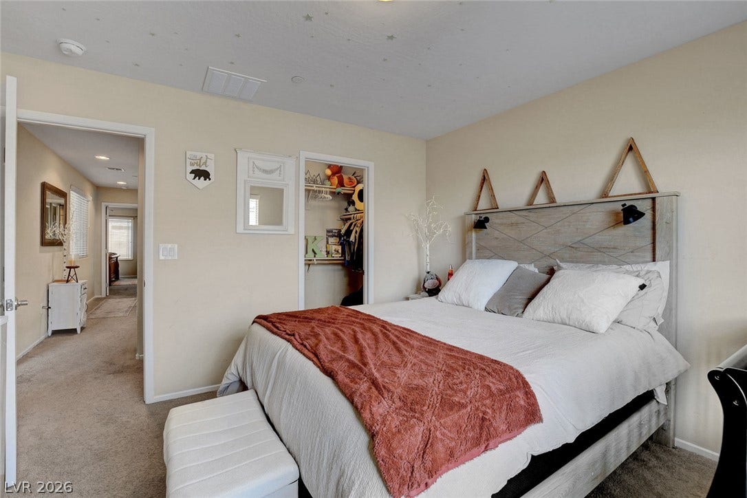 3924 Juanita May Avenue, North Las Vegas, NV 89032 Soft carpeting underfoot anchors this cozy second bedroom featuring an adjacent walk-in closet.