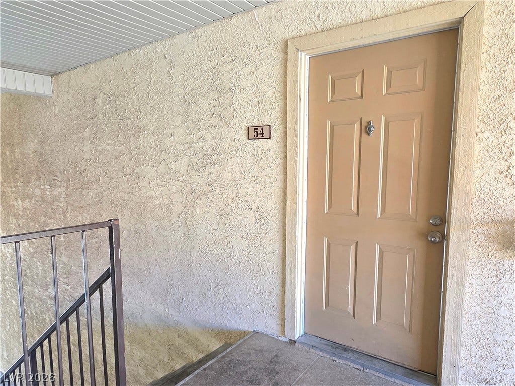 4470 Sandy River Drive, #54, Las Vegas, NV 89103 A private entrance features textured stucco walls and durable concrete flooring.
