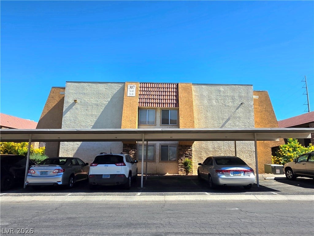 4470 Sandy River Drive, #54, Las Vegas, NV 89103 Stucco and stone architectural detailing frames the exterior of this multi-family residential building.