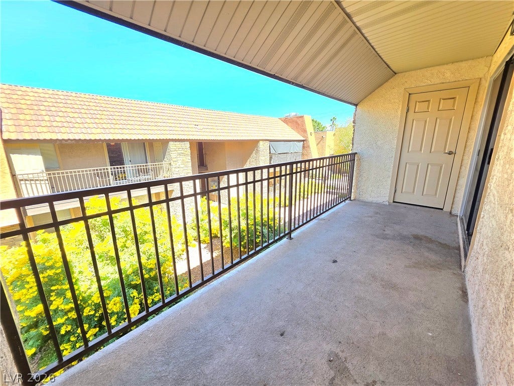 4470 Sandy River Drive, #54, Las Vegas, NV 89103 Concrete flooring and sturdy metal railings define this functional upper-level outdoor balcony space.