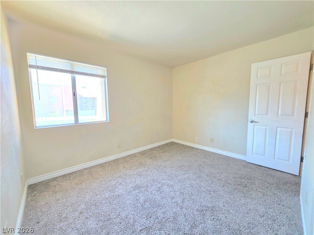 4470 Sandy River Drive, #54, Las Vegas, NV 89103 A window bathes this carpeted bedroom in soft natural light.