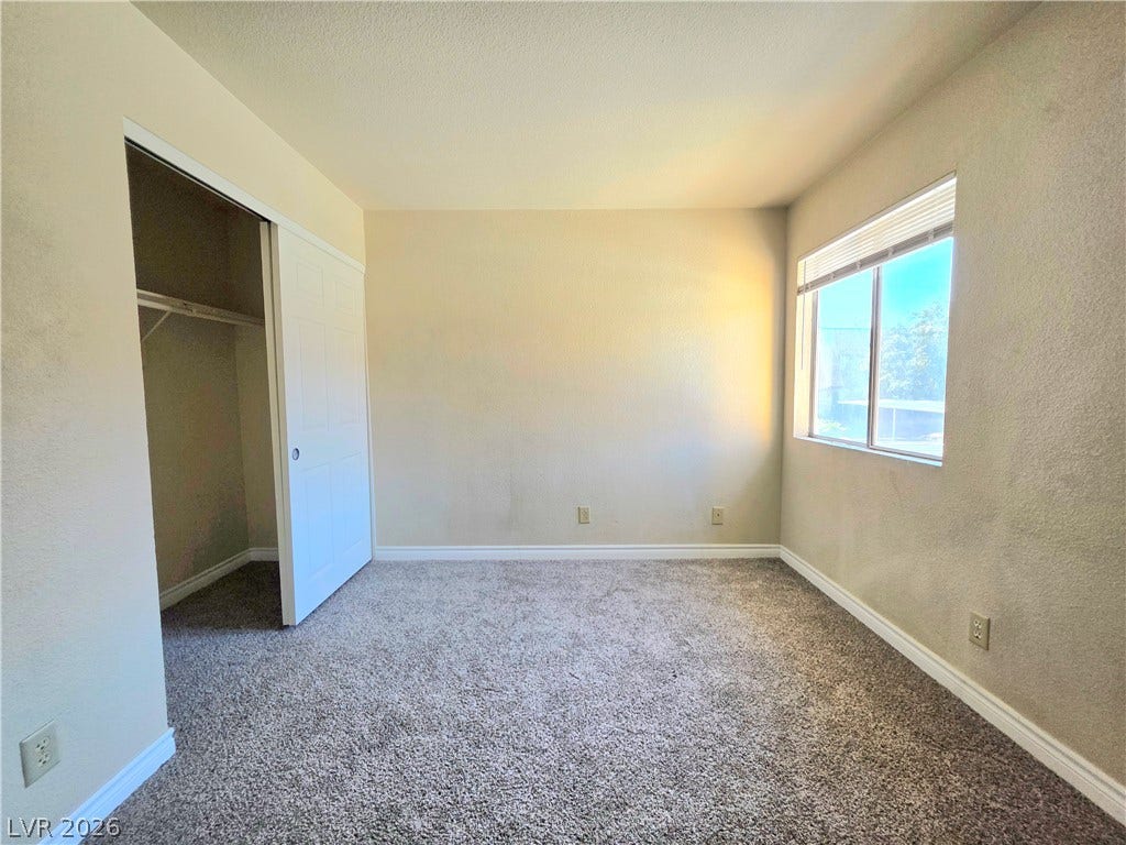 4470 Sandy River Drive, #54, Las Vegas, NV 89103 Plush carpeting and a large window bring warmth and natural light to this bedroom.
