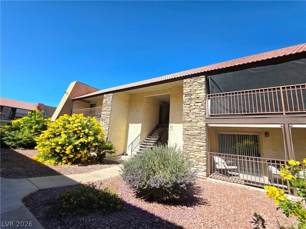 4470 Sandy River Drive, #54, Las Vegas, NV 89103 Warm stucco and textured stone accents define this inviting multi-level residential exterior.