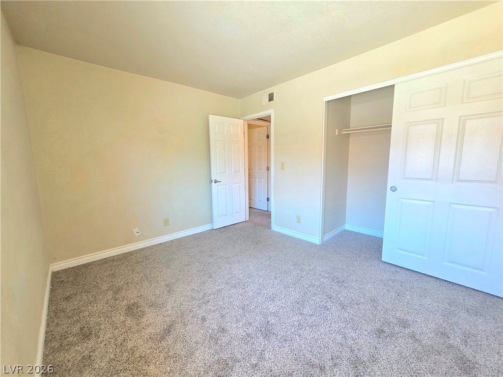 4470 Sandy River Drive, #54, Las Vegas, NV 89103 Soft carpeting underfoot and an integrated closet define this comfortable secondary bedroom.