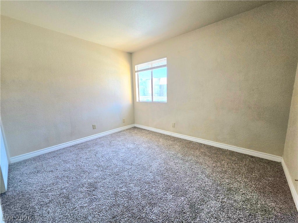 4470 Sandy River Drive, #54, Las Vegas, NV 89103 Soft carpet and a classic window define this versatile secondary bedroom space.