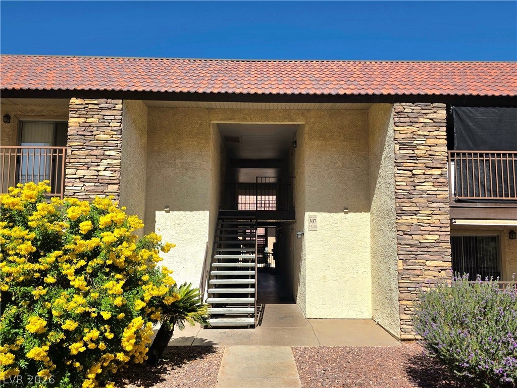 4470 Sandy River Drive, #54, Las Vegas, NV 89103 Stucco and stone accents define this inviting multi-level exterior entryway.