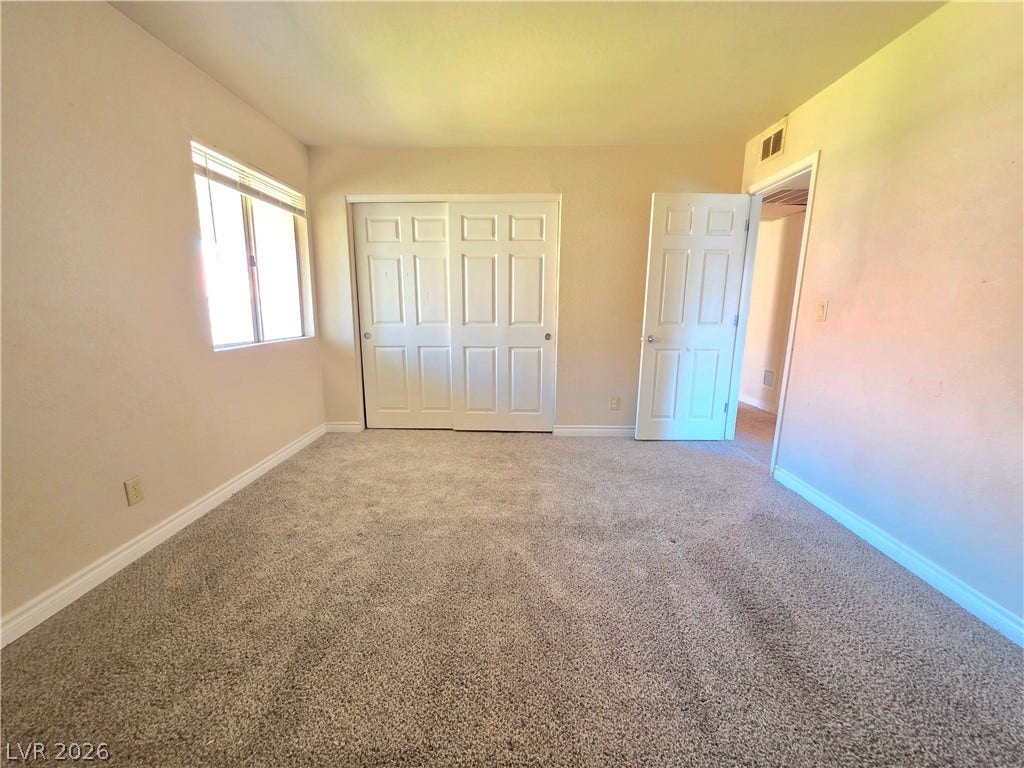 4470 Sandy River Drive, #54, Las Vegas, NV 89103 Plush carpeting and integrated storage closets define this comfortable secondary bedroom.