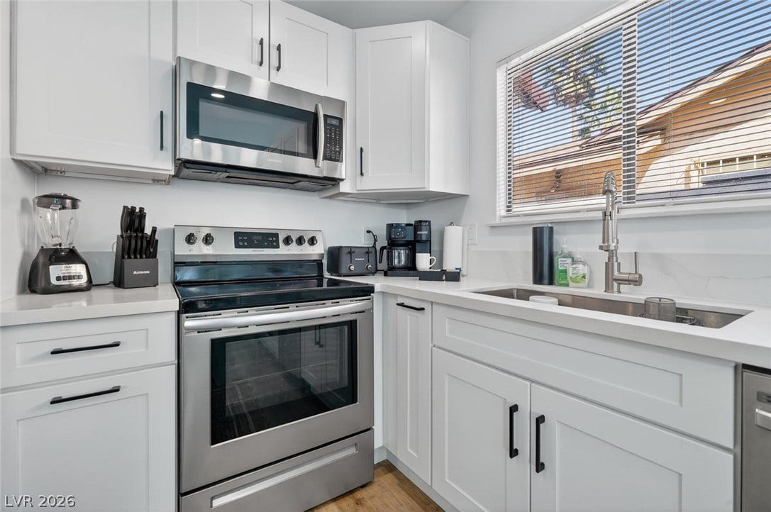 6191 Bullion Boulevard, Las Vegas, NV 89103 Crisp white cabinetry pairs perfectly with solid stone countertops and modern stainless steel appliances.