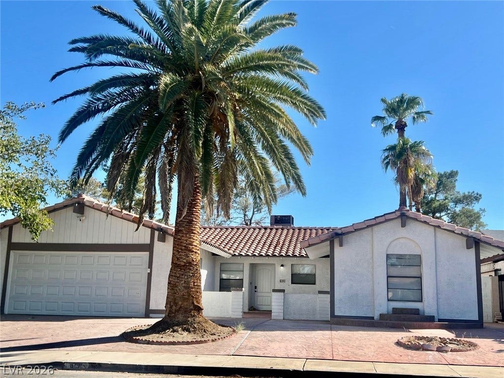 6191 Bullion Boulevard, Las Vegas, NV 89103 Spanish tile roofing and architectural details define this classic single-story exterior facade.