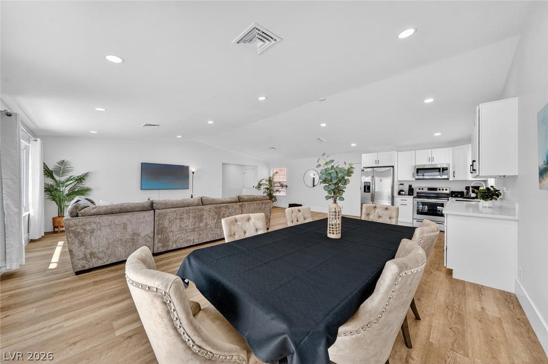 6191 Bullion Boulevard, Las Vegas, NV 89103 Smooth wood floors flow seamlessly through this open-concept layout connecting the kitchen and living areas.