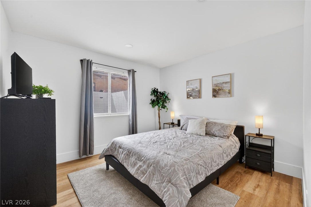 6191 Bullion Boulevard, Las Vegas, NV 89103 Rich hardwood flooring complements the clean lines and recessed lighting of this peaceful bedroom.