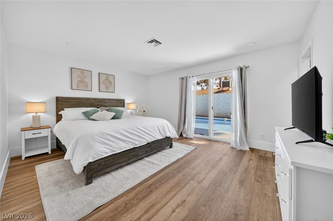 6191 Bullion Boulevard, Las Vegas, NV 89103 Sliding glass doors open directly to the pool patio from this airy bedroom.