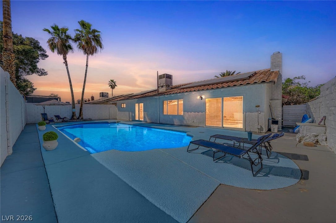 6191 Bullion Boulevard, Las Vegas, NV 89103 A private swimming pool and expansive decking define this backyard retreat beneath the evening sky.