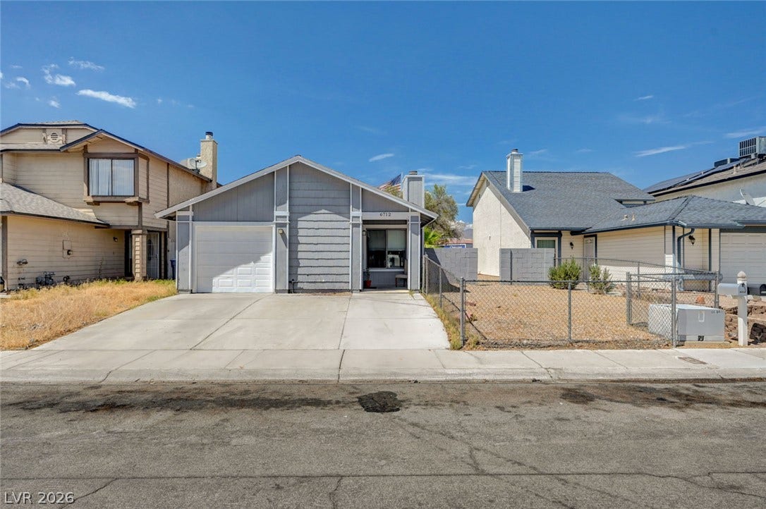 6712 Accent Court, Las Vegas, NV 89108 Clean lines and a spacious driveway define this single-story home with classic siding architecture.