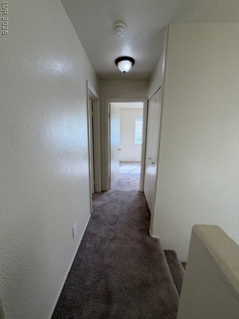 2506 Lady Elizabeth Court, North Las Vegas, NV 89031 Neutral tone carpeting lines the hallway and stairs of this multi-level home layout.
