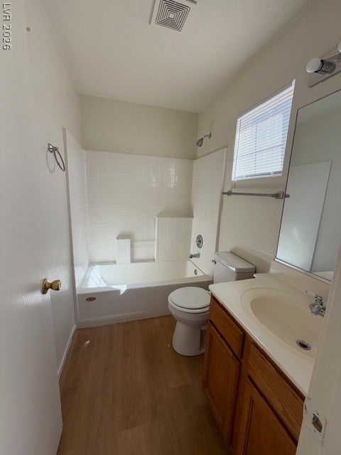 2506 Lady Elizabeth Court, North Las Vegas, NV 89031 Natural light streams through a skylight over the neutral tiled tub and vanity area.