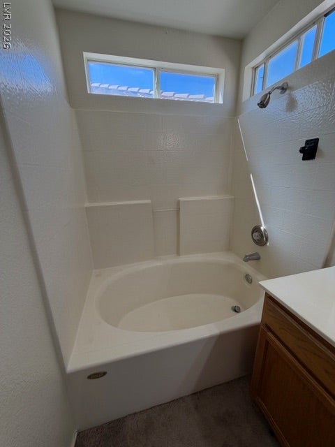 2506 Lady Elizabeth Court, North Las Vegas, NV 89031 Natural light streams through high windows over the deep soaking tub.