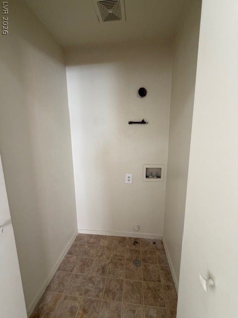 2506 Lady Elizabeth Court, North Las Vegas, NV 89031 A dedicated utility space with durable tile and vinyl flooring awaits a laundry setup.