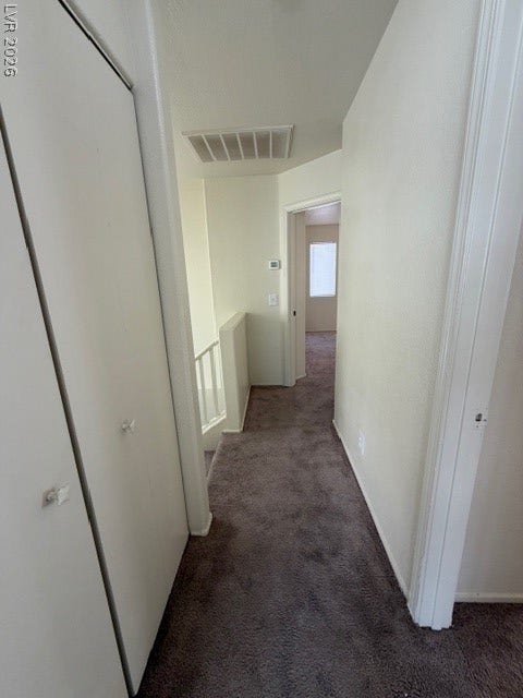2506 Lady Elizabeth Court, North Las Vegas, NV 89031 Soft carpeting lines the upper hallway leading towards the staircase landing.
