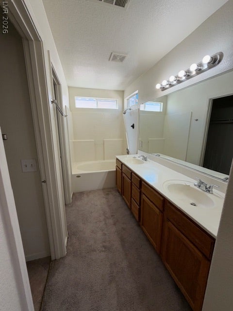 2506 Lady Elizabeth Court, North Las Vegas, NV 89031 Double vanities and a combination tub and shower define this functional bathroom layout.
