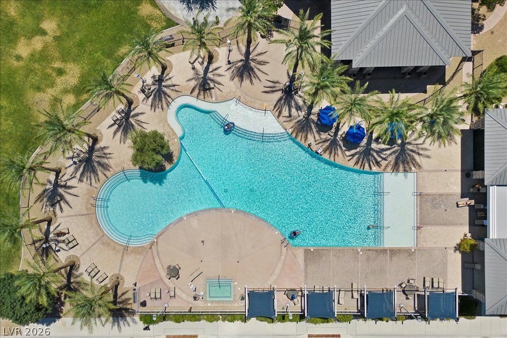 6722 Desert Crimson Street, Las Vegas, NV 89148 An aerial perspective showcases a resort-style swimming pool lined with palm trees and sunbathing areas.