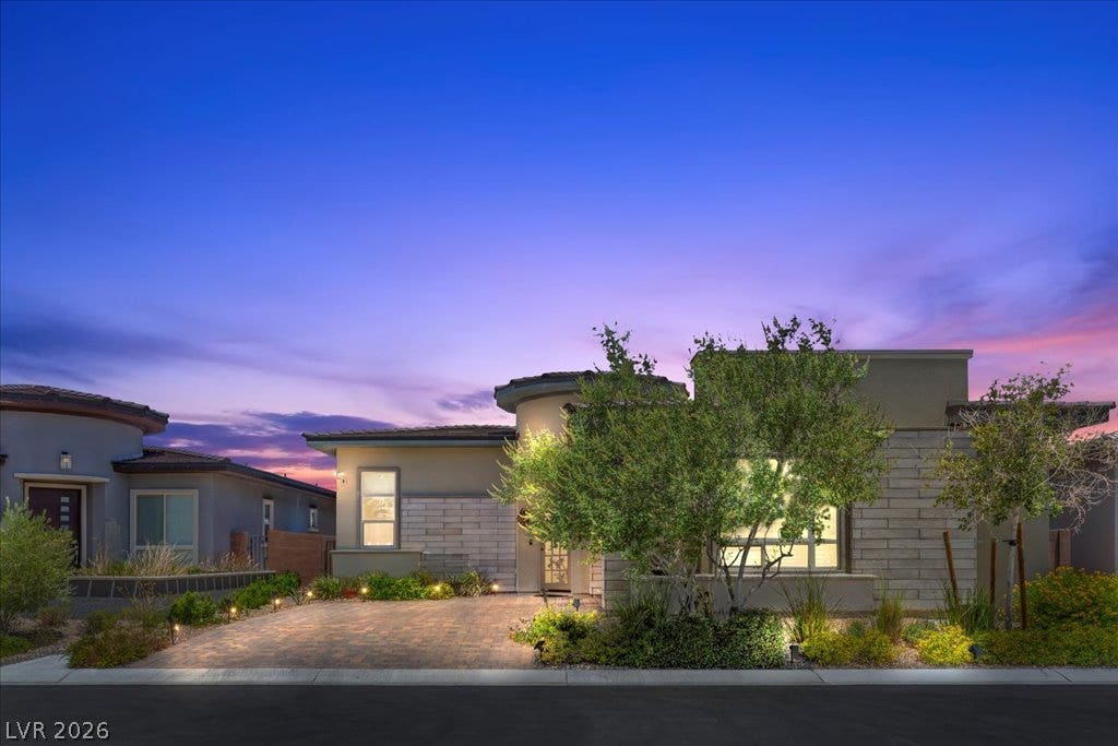 6722 Desert Crimson Street, Las Vegas, NV 89148 Striking contemporary lines and stone accents frame this modern facade under a twilight sky.