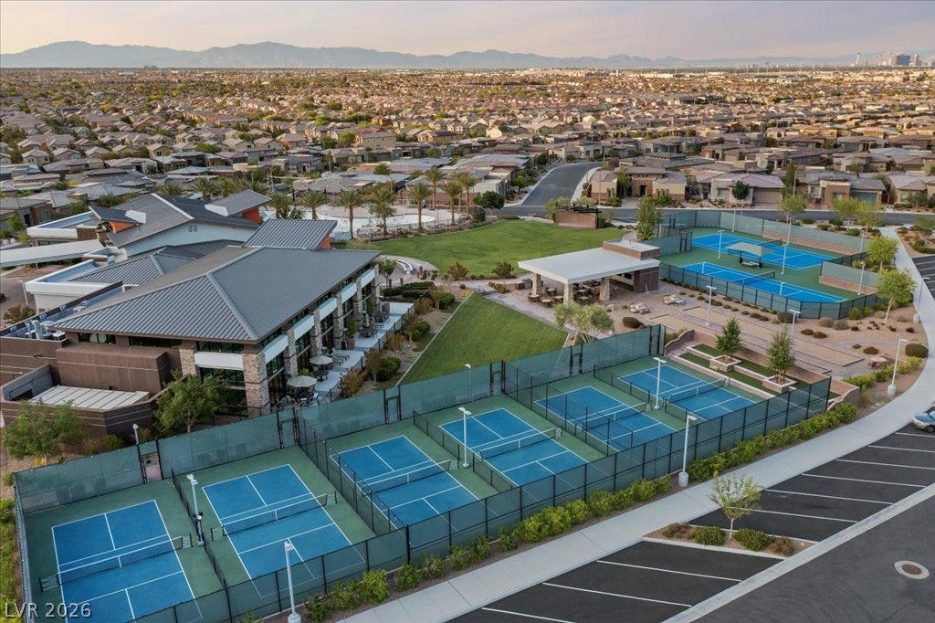 6722 Desert Crimson Street, Las Vegas, NV 89148 An aerial perspective showcases extensive community recreation facilities and courts nestled in a vast suburban landscape.