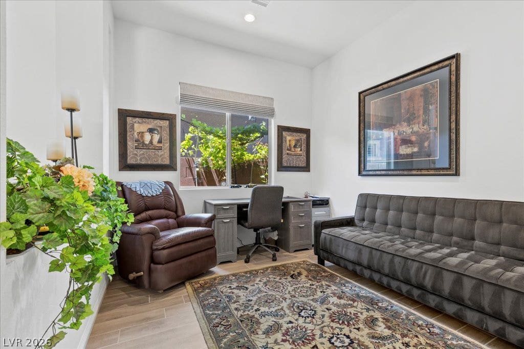 6722 Desert Crimson Street, Las Vegas, NV 89148 Gleaming wood-look tile flooring and high ceilings elevate this quiet home workspace.