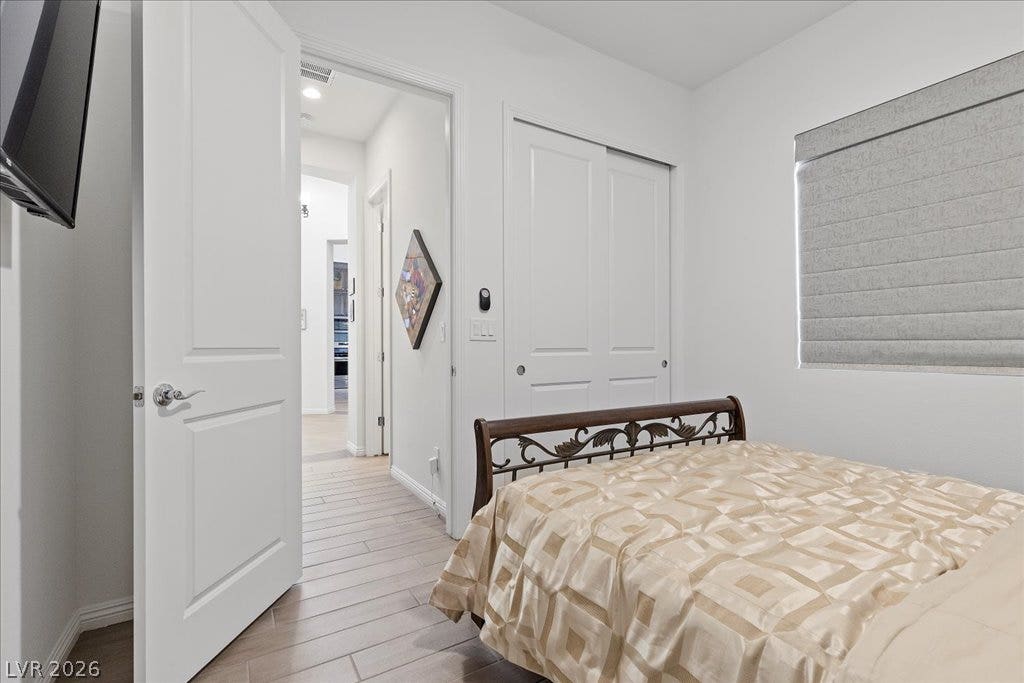 6722 Desert Crimson Street, Las Vegas, NV 89148 A quiet bedroom features tile-style flooring and direct access to the main hallway.
