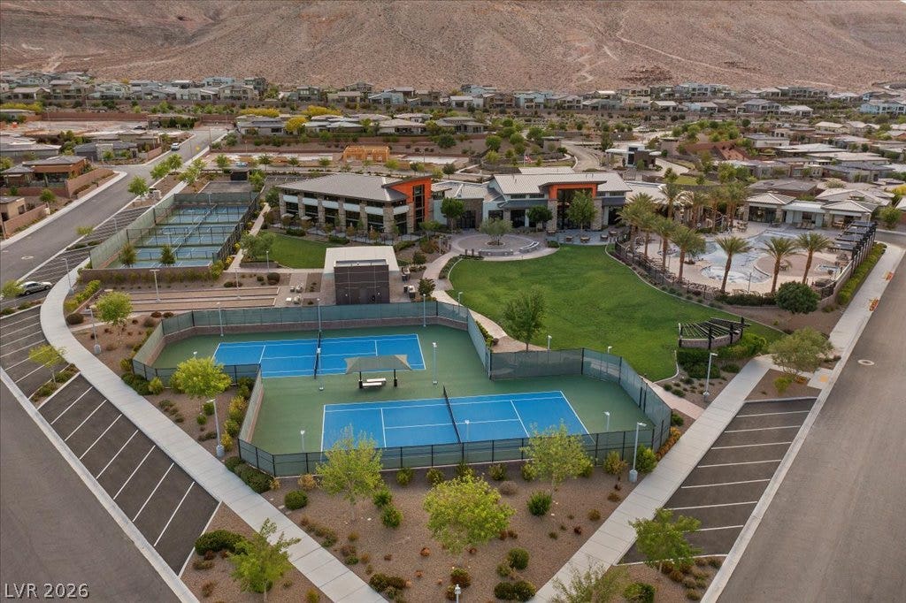 6722 Desert Crimson Street, Las Vegas, NV 89148 Manicured athletic courts and resort amenities sit nestled against a dramatic mountain backdrop.