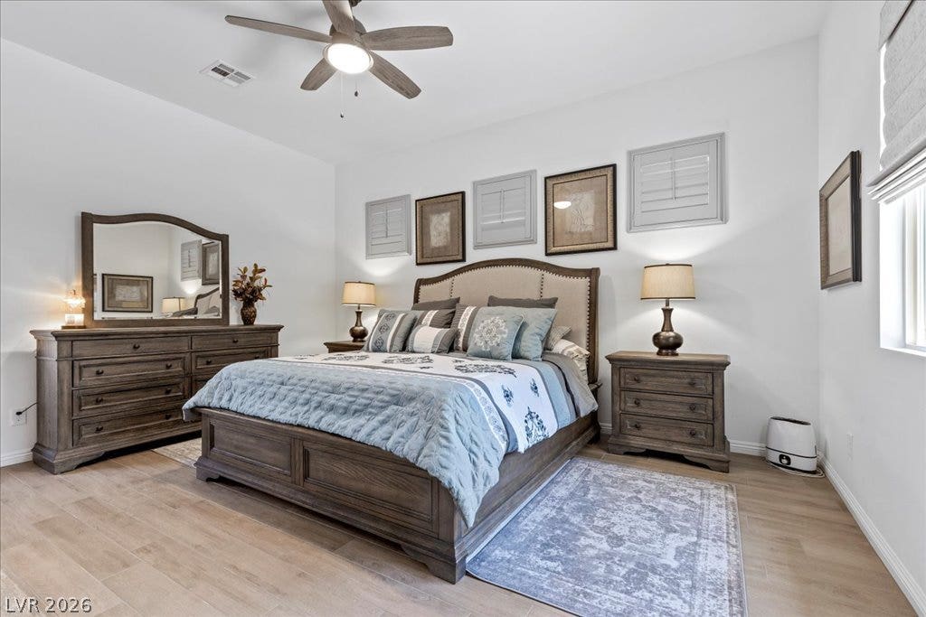 6722 Desert Crimson Street, Las Vegas, NV 89148 Gleaming wood-look tile flooring and neutral walls define this airy primary suite.