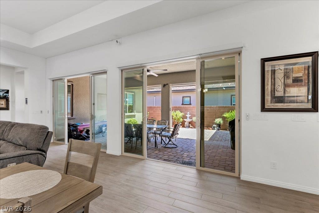 6722 Desert Crimson Street, Las Vegas, NV 89148 Wide sliding glass doors connect the interior living space directly to the paved back patio.