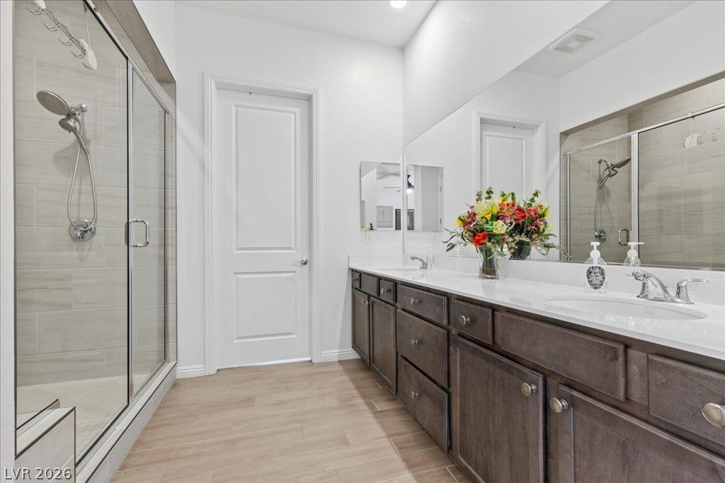6722 Desert Crimson Street, Las Vegas, NV 89148 An expansive double vanity and a glass-enclosed walk-in shower anchor this modern primary bath.