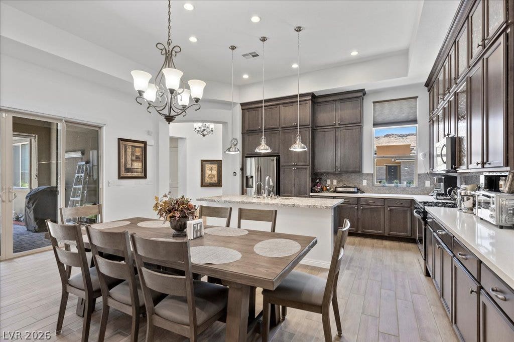 6722 Desert Crimson Street, Las Vegas, NV 89148 Gleaming stone countertops and custom cabinetry define this thoughtfully designed dining and culinary space.