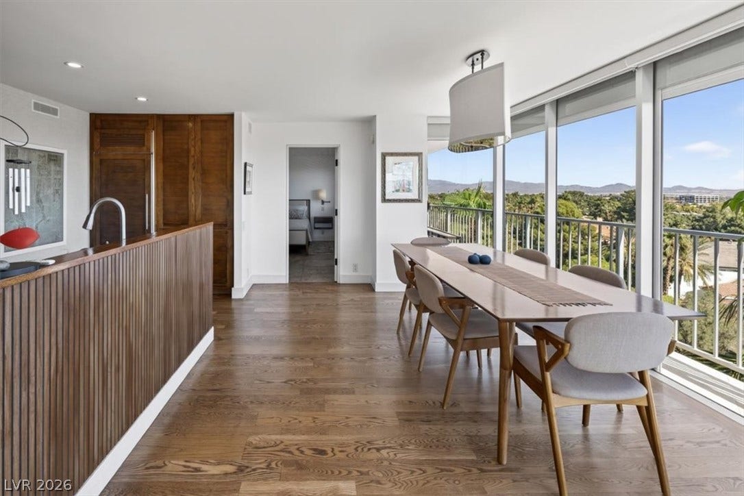 3111 Bel Air Drive, #7D, Las Vegas, NV 89109 Gleaming hardwood floors and a wall of windows define this light-filled dining space.