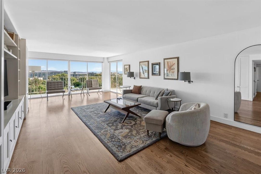 3111 Bel Air Drive, #7D, Las Vegas, NV 89109 Gleaming hardwood floors and a wall of glass highlight this airy living room.