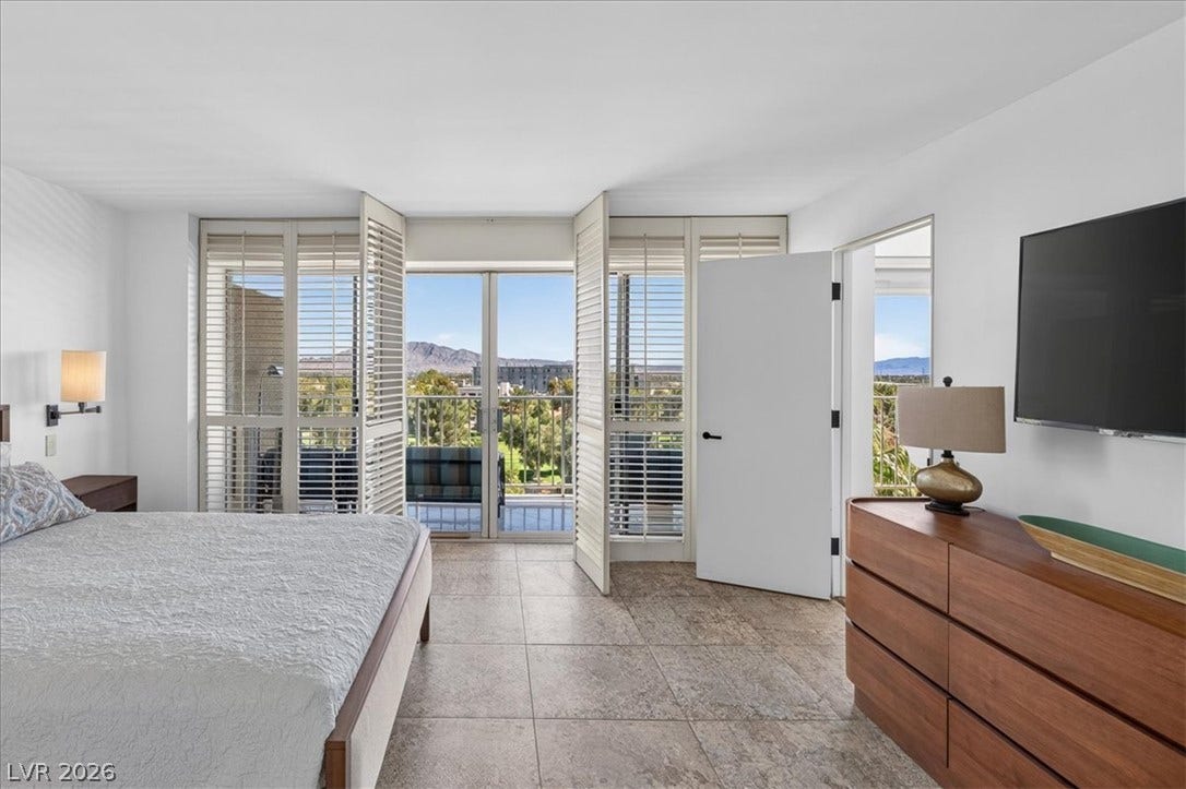 3111 Bel Air Drive, #7D, Las Vegas, NV 89109 Glass sliding doors open to a private balcony overlooking mountain views.
