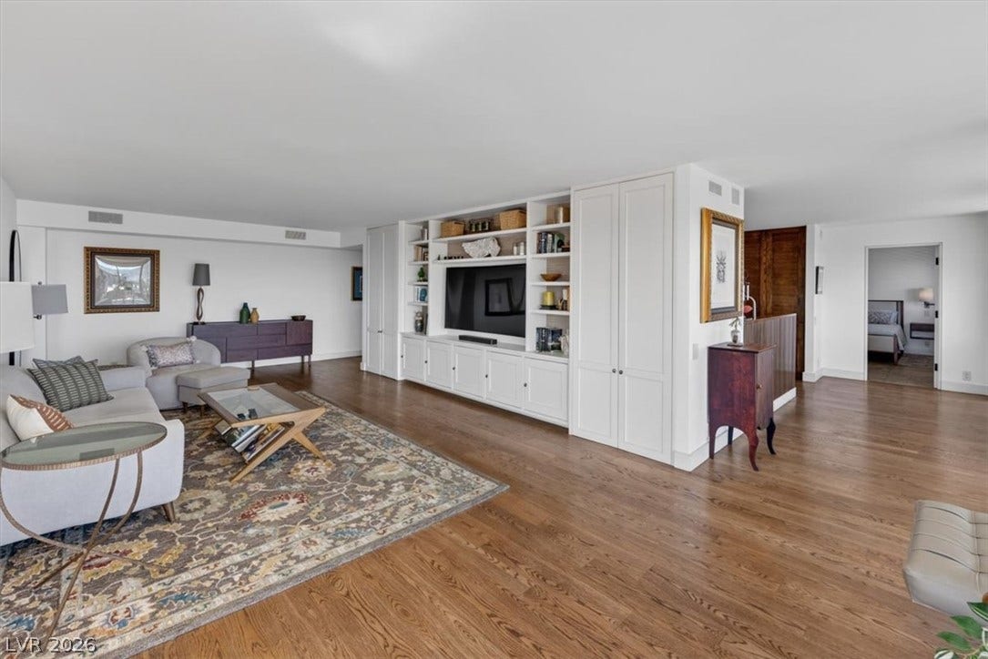 3111 Bel Air Drive, #7D, Las Vegas, NV 89109 Rich hardwood flooring anchors the open living space complete with custom built-in cabinetry.