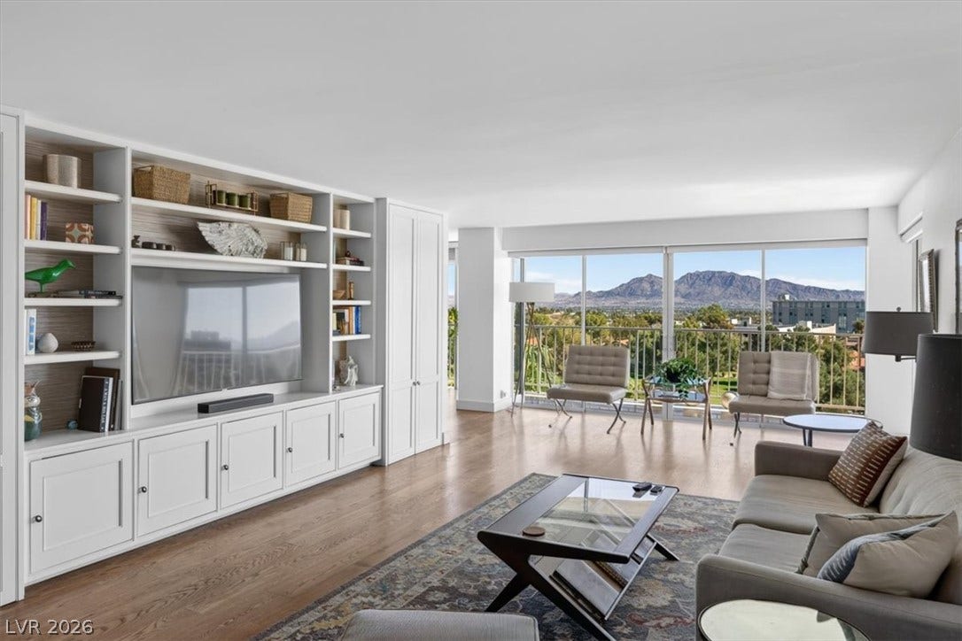 3111 Bel Air Drive, #7D, Las Vegas, NV 89109 Gleaming wood floors and a sprawling built-in media center frame majestic mountain views.