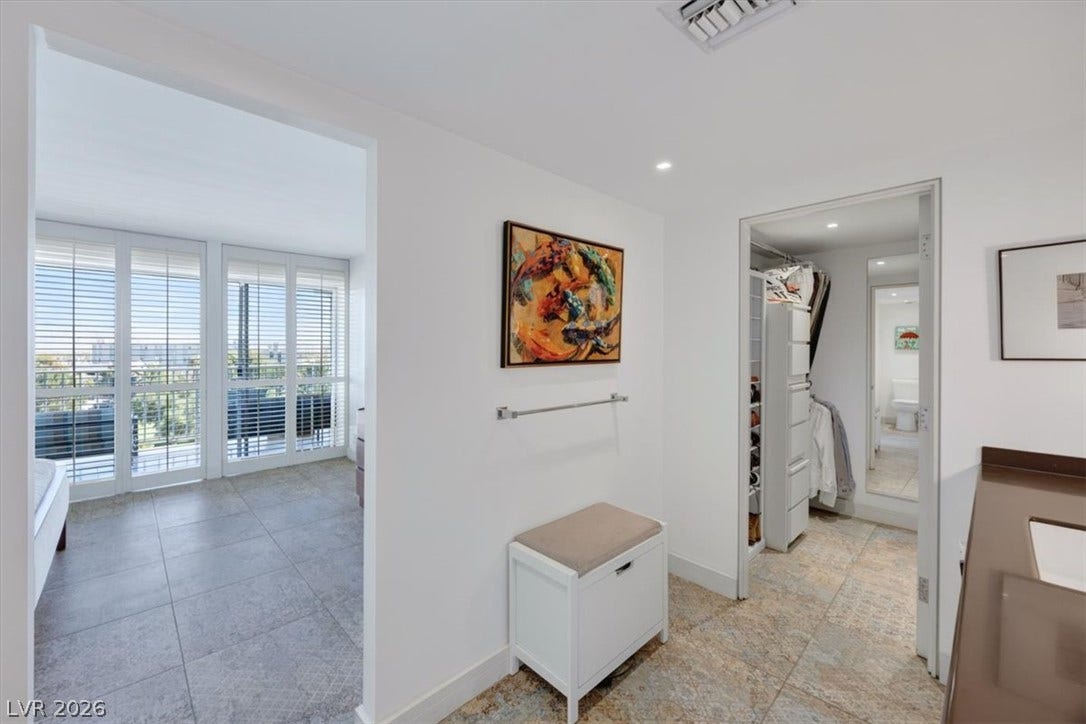 3111 Bel Air Drive, #7D, Las Vegas, NV 89109 Smooth tile floors run through this bright master suite hallway leading to a walk-in closet.