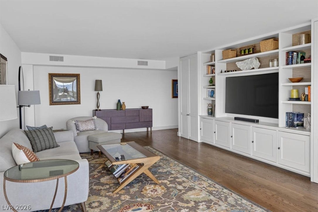 3111 Bel Air Drive, #7D, Las Vegas, NV 89109 Gleaming hardwood floors and a massive built-in media center define this spacious living area.