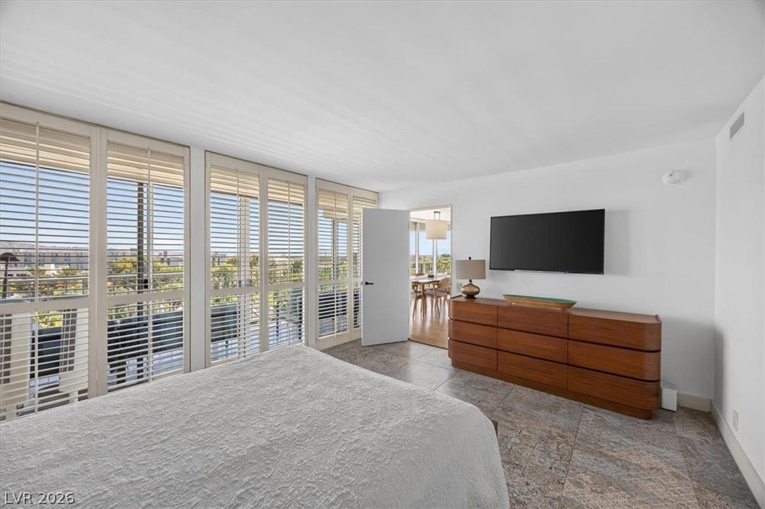 3111 Bel Air Drive, #7D, Las Vegas, NV 89109 Floor-to-ceiling windows with plantation shutters fill this spacious bedroom with natural light.