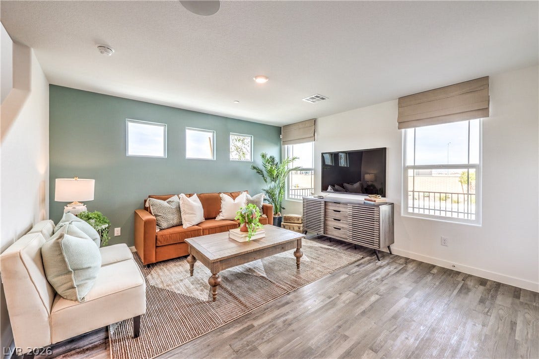 923 Black Heron Street, Henderson, NV 89011 Natural light pours across smooth flooring and clean architectural lines in this inviting living space.