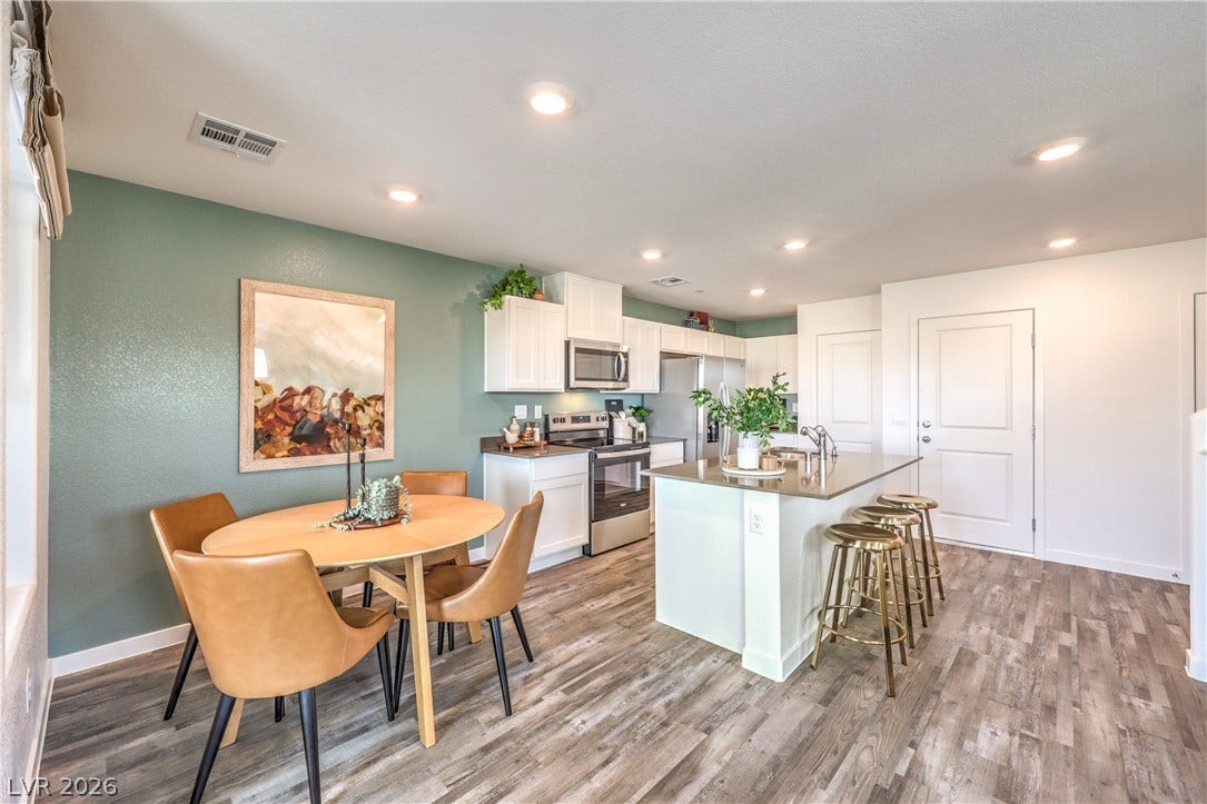 923 Black Heron Street, Henderson, NV 89011 An open floorplan design seamlessly connects the modern kitchen and casual dining area.