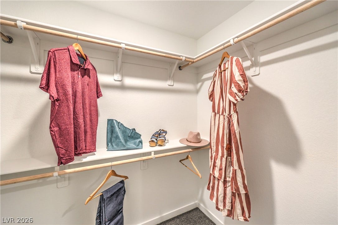 923 Black Heron Street, Henderson, NV 89011 Ample hanging space and built-in shelving maximize storage options in this carpeted closet.