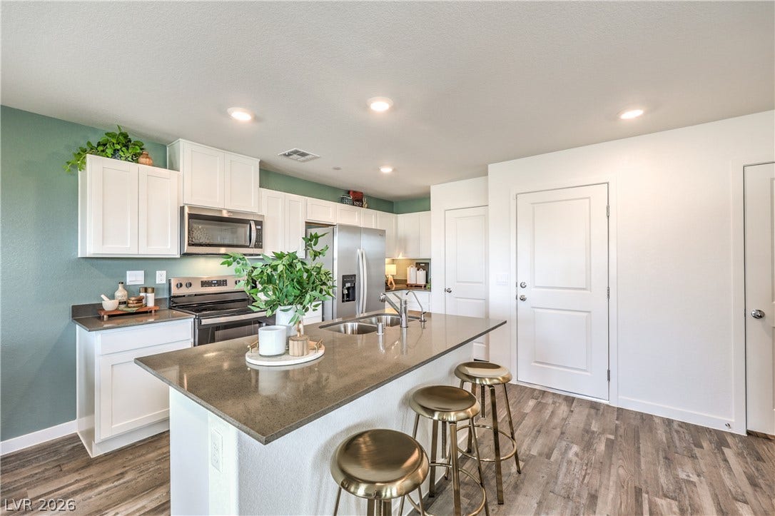 923 Black Heron Street, Henderson, NV 89011 Smooth quartz countertops and recessed lighting elevate this modern culinary space.