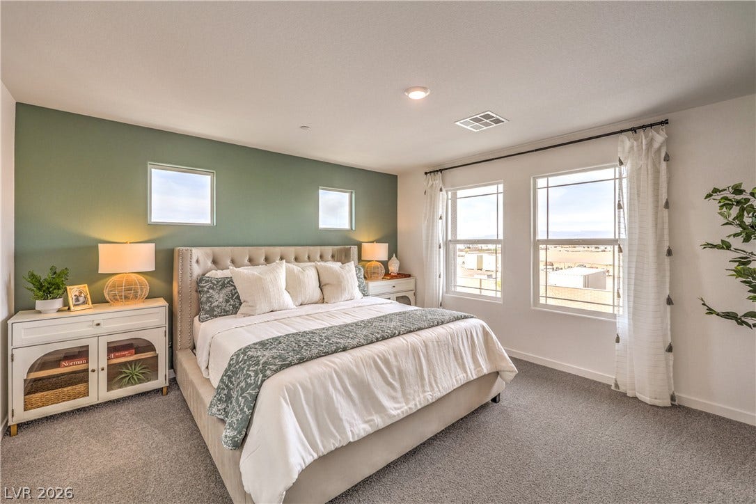 923 Black Heron Street, Henderson, NV 89011 Natural light pours through multiple windows, illuminating the plush carpeting and clean architectural lines.