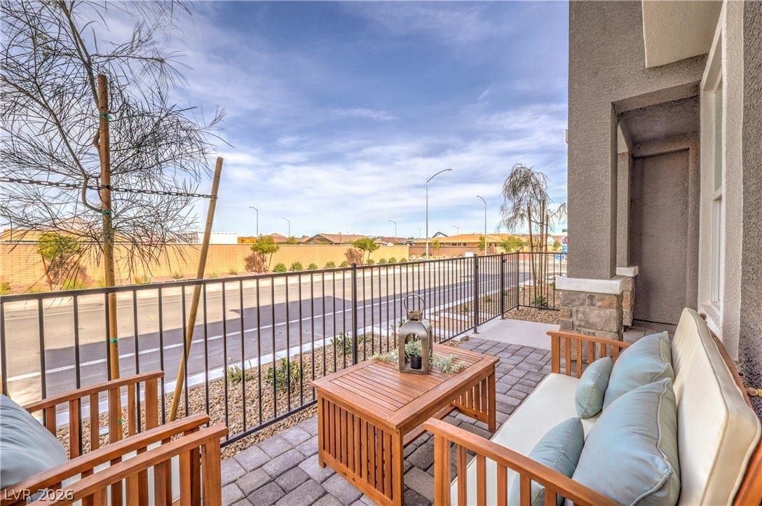 923 Black Heron Street, Henderson, NV 89011 An inviting paved patio area is bordered by secure metal fencing and stone column accents.
